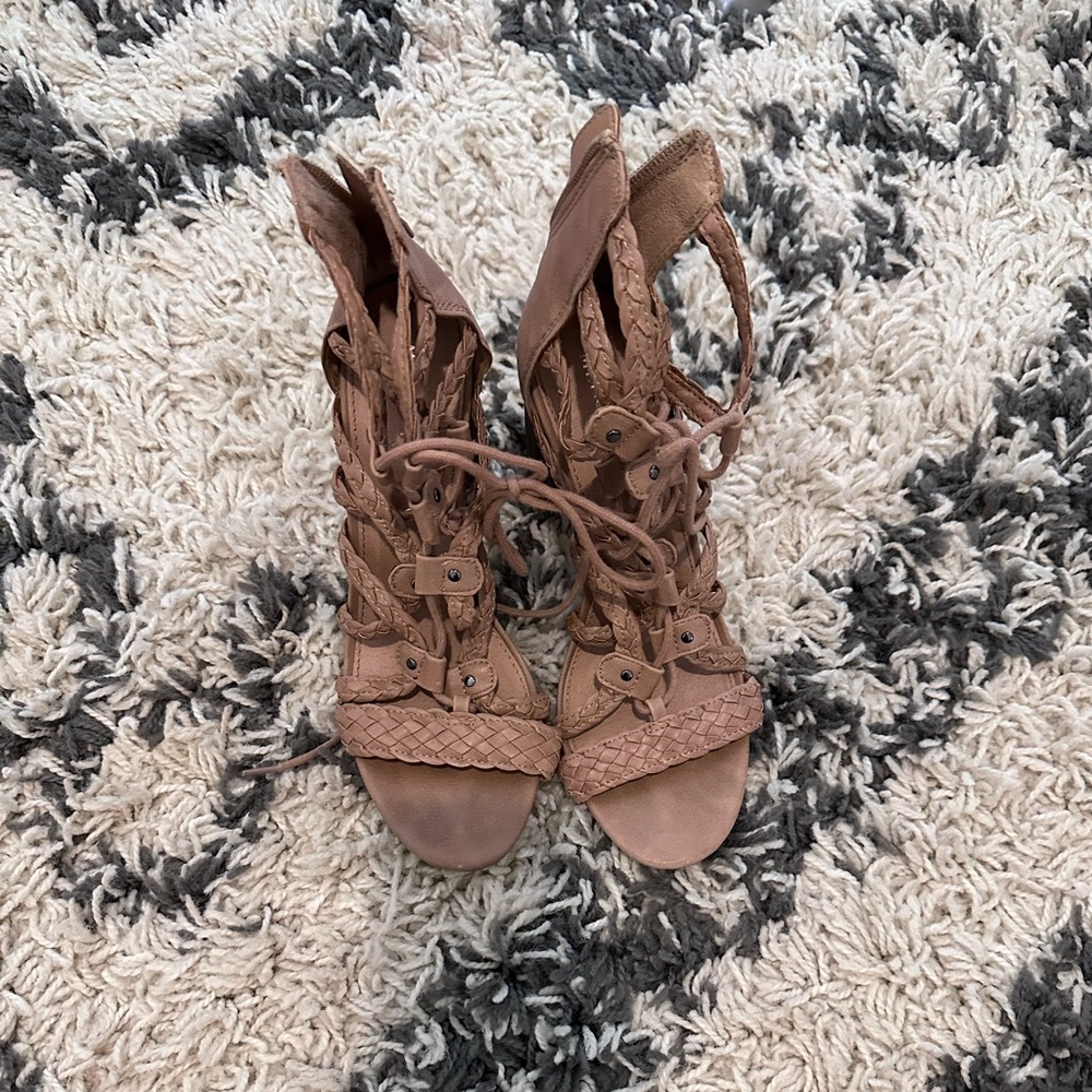 Strappy heeled sandals. They tie as well as zip in the back